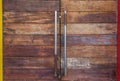 Old wooden locked door with long metal handles Royalty Free Stock Photo