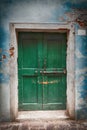 Old wooden locked green door