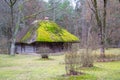 Old wooden log house. View with window, front door and with moss on the roof. Royalty Free Stock Photo