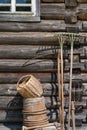 Old wooden log texture wall with window and vintage garden tools