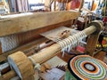 An old wooden loom weaves a carpet Royalty Free Stock Photo