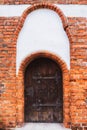 Old wooden medieval door with iron hinges. olszty, Poland. Royalty Free Stock Photo