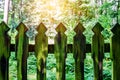 Wooden mossy fence in the forest