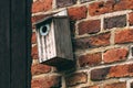 Old wooden nesting box bird house on the wall