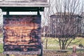 Old wooden noticeboard on the background of the ancient city and trees, copy space