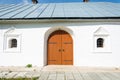 Old wooden orange door in the monastery Church. Royalty Free Stock Photo