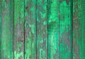 Old wooden painted light green rustic fence, paint peeling background.