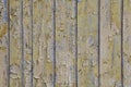 Old wooden painted rustic wall with blue flaky dye. Faded wood planks close-up