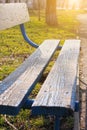 Old wooden park bench close-up on blurred green nature background. Backdrop for text sign, copy space vertical banner Royalty Free Stock Photo