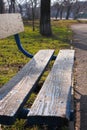 Old wooden park bench close-up on blurred green nature background. Backdrop for text sign, copy space vertical banner Royalty Free Stock Photo