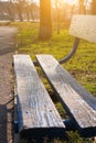 Old wooden park bench close-up on blurred green nature background. Backdrop for text sign, copy space vertical banner Royalty Free Stock Photo