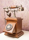 Old wooden phone. Vintage wooden telephone on white table. Retro Royalty Free Stock Photo