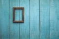 Wooden photo frame on wooden wall Royalty Free Stock Photo