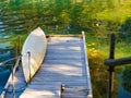 Old wooden pier with boat on lake Royalty Free Stock Photo