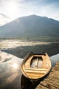 Old wooden pier with boat on Plavsko lake between water lilies, Montenegro, Europe Royalty Free Stock Photo