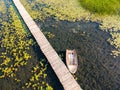 Old wooden pier with boat on Plavsko lake between water lilies, Montenegro, Europe Royalty Free Stock Photo