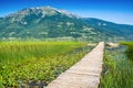 Old wooden pier with boat on Plavsko lake between water lilies, Montenegro, Europe Royalty Free Stock Photo