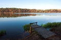 Old wooden pier for fishing in autumn forest lake Royalty Free Stock Photo