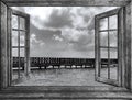 Old wooden pier goes to sea opened window Royalty Free Stock Photo