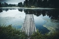 Old wooden pier in lake, Idyllic tranquil view nature background with reflection in water Royalty Free Stock Photo