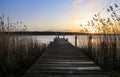 old wooden pier at small beautiful pond on sunset Royalty Free Stock Photo