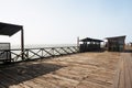 old wooden pier with railing in the pacific ocean and blue sky pimentel chiclayo per