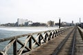 old wooden pier from railing in the pacific ocean and blue sky pimentel chiclayo peru