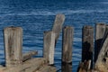 Old wooden pillars above the water. Ruins of the pier.