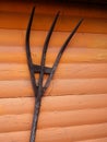 Old Wooden Pitchfork against a Bright Orange Wall Royalty Free Stock Photo