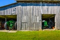 Old wooden plank barn for storing tractors and farm equipment Royalty Free Stock Photo