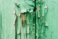 Old wooden planks with cracked peeling green paint. Painted texture background. Rustic background Royalty Free Stock Photo
