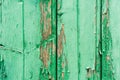 Old wooden planks with cracked peeling green paint. Painted texture background. Rustic background Royalty Free Stock Photo