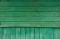 Old wooden planks with cracked and peeling green paint. Wood texture Royalty Free Stock Photo