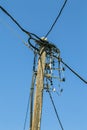 Old wooden powerline, isolated on blue sky Royalty Free Stock Photo