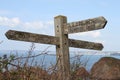 Old wooden public footpath sign overlooking Hope Cove in Devon, United Kingdom Royalty Free Stock Photo