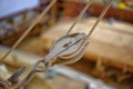 Old wooden pulley hanging in a boat builders shop Royalty Free Stock Photo