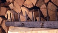 Old wooden rake on a background of wood stack