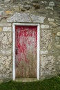 Old red peeled door of a windmill Royalty Free Stock Photo