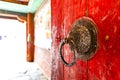 Old wooden red entrance door of the Gangtey Goemba monastery in Phobjikha Valley, Central Bhutan, Bhutan Royalty Free Stock Photo