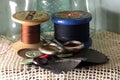 OLD WOODEN REELS WITH COTTON THREAD AND NEEDLEWORK ITEMS Royalty Free Stock Photo