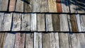 Old wooden roof tiles background. Wood background. Vintage. Wood roofing pattern detail. Old brown wooden shingle roof.View of