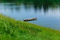 Old wooden rowing boat on the blue river water Royalty Free Stock Photo