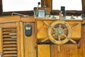 Old wooden rudder with brass cardinal points of an italian fishing boat