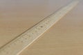 Old wooden ruler on the table Royalty Free Stock Photo