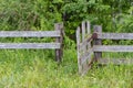 Old wooden rural fence with rickety wicket, untreated wood with signs of aging with fungus and moss. Wattle fence wooden planks. Royalty Free Stock Photo