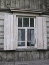 Old wooden rural house with an open window, historical monument