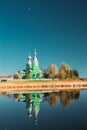 Old Wooden Russian Orthodox Church Near Lake In Early Spring Or Late Autumn Season. Sunny Day Royalty Free Stock Photo