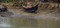Old wooden rustic boat ported on a bank of a small river with fresh water