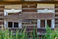 Old wooden rustic ruined abandoned house with boarded up windows on a bright summer sunny day Royalty Free Stock Photo