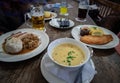 Old wooden rustic table full of food - German cuisine and different types of cold tasty beer in glasses Royalty Free Stock Photo